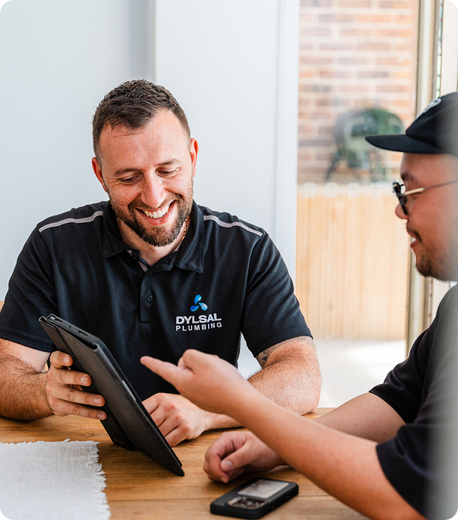 DYLSAL plumber walking a customer through a plumbing report