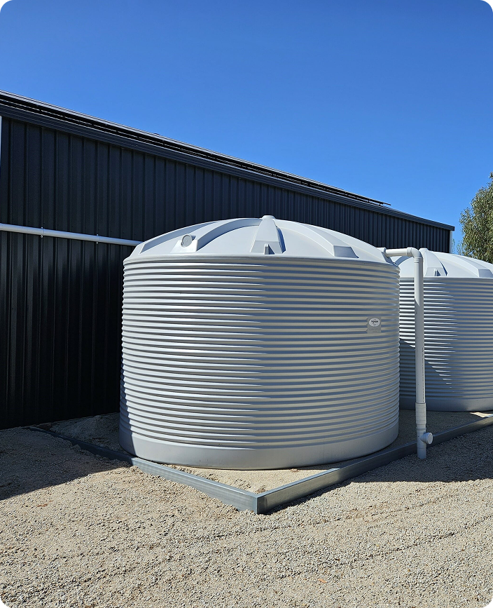 Large above-ground rainwater tank installed by Dylsal Plumbing